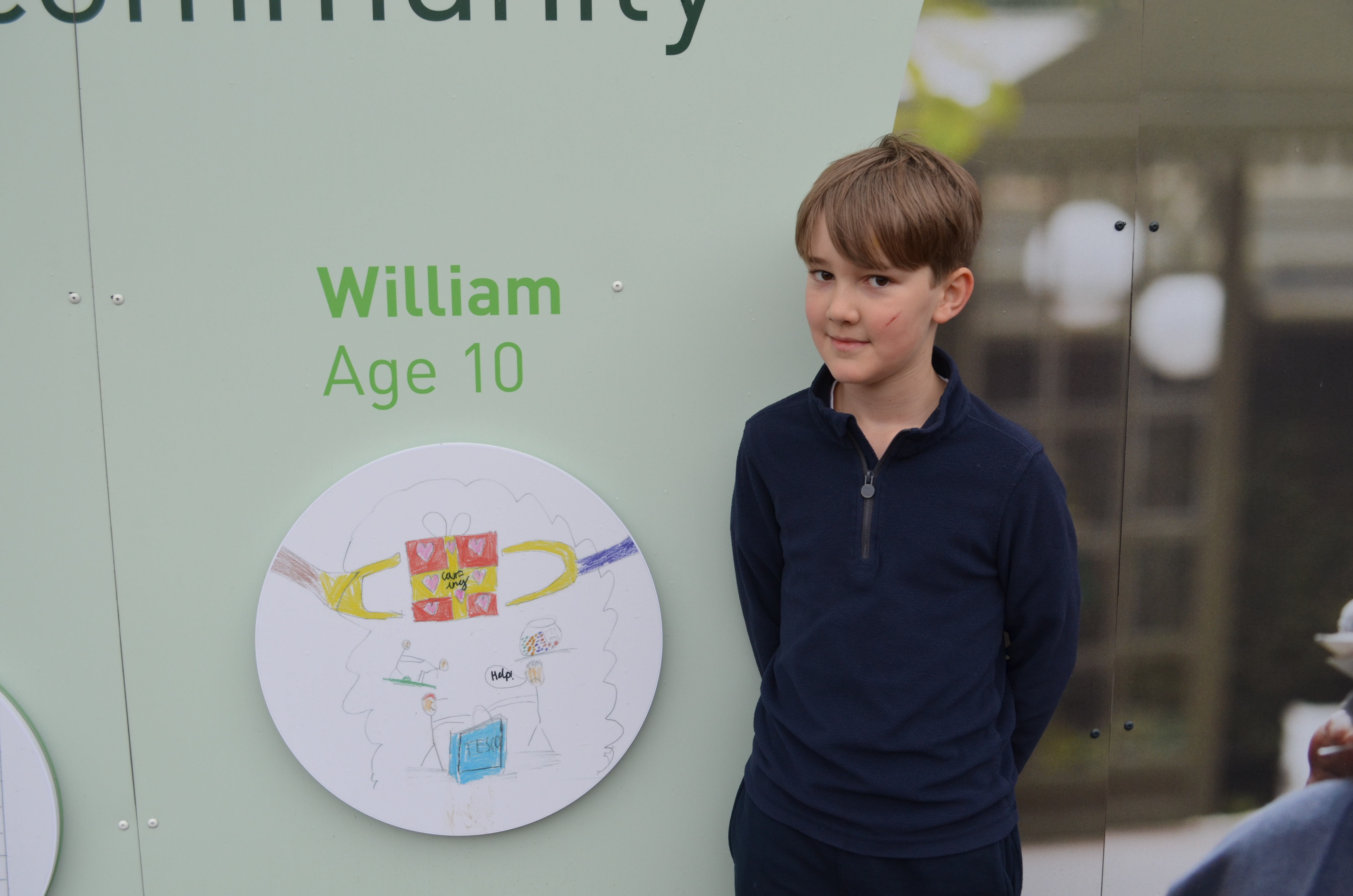 William standing beside his artwork