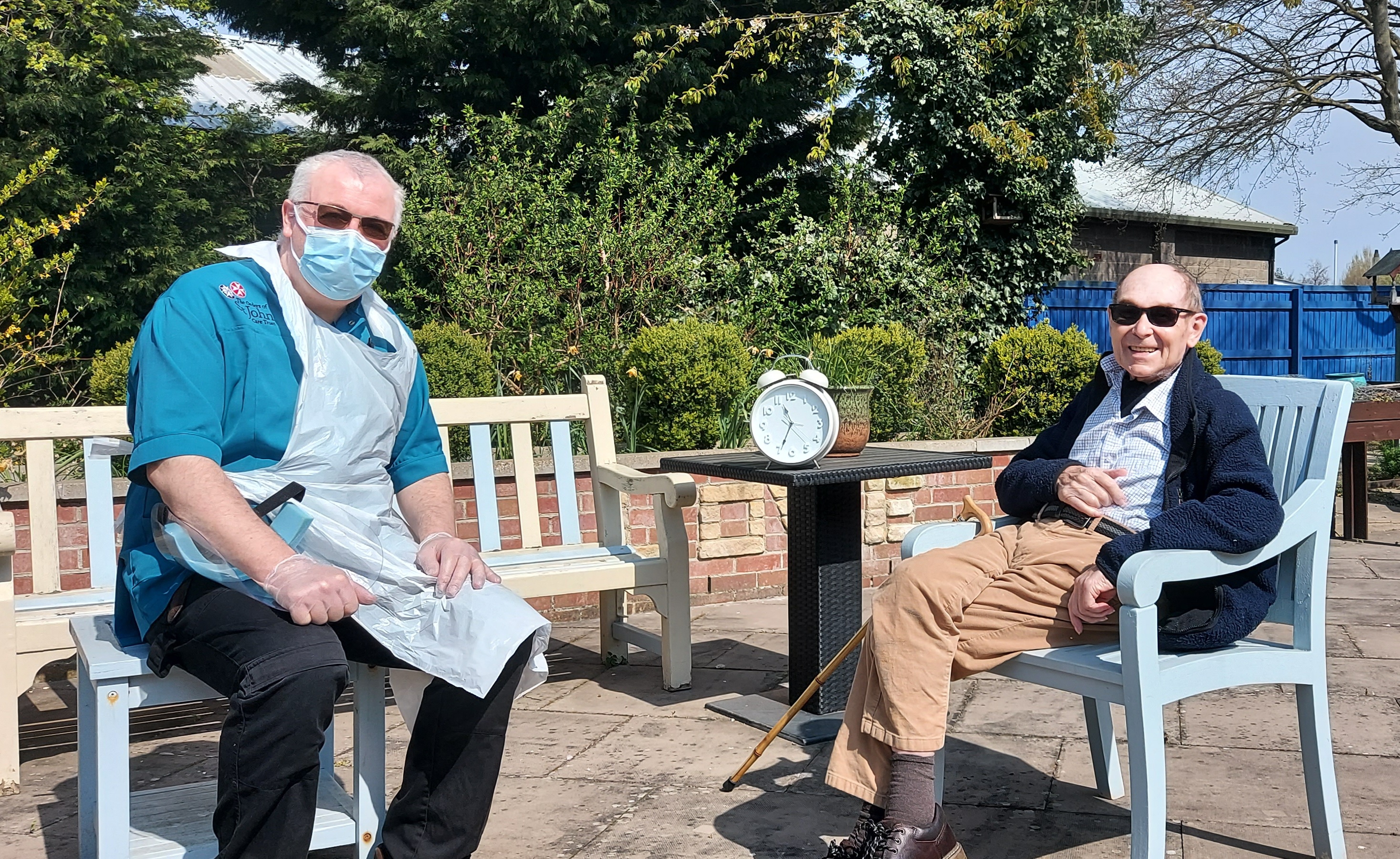 Housekeeper Richard talking with Derrick about his time in Uganda