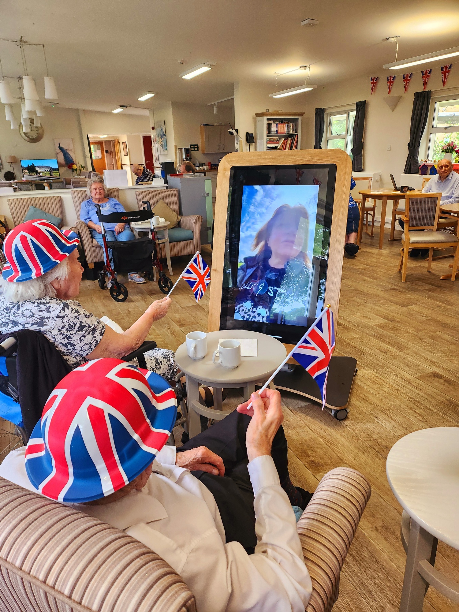 Marston Court residents viewing videos of Sharon Home Manager at the D-Day beaches in Normandy