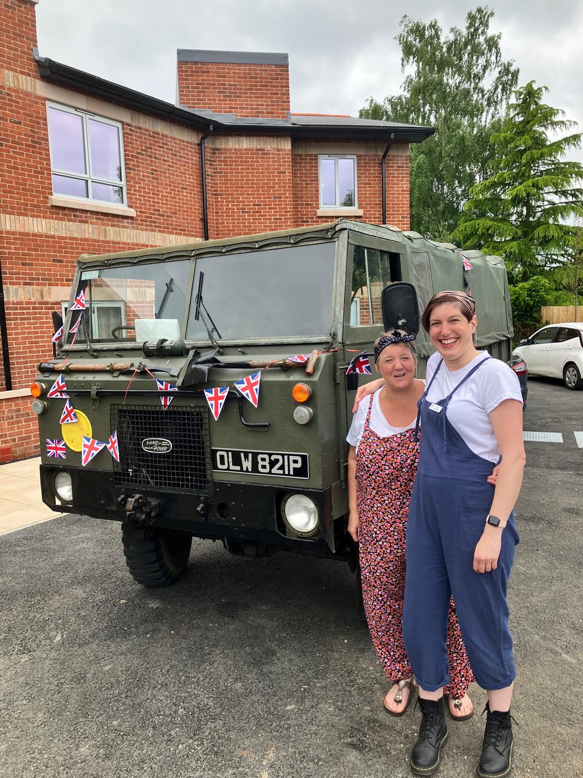 Sally and Jo outside Wellford Gardens with the army vehicle on display for D Day