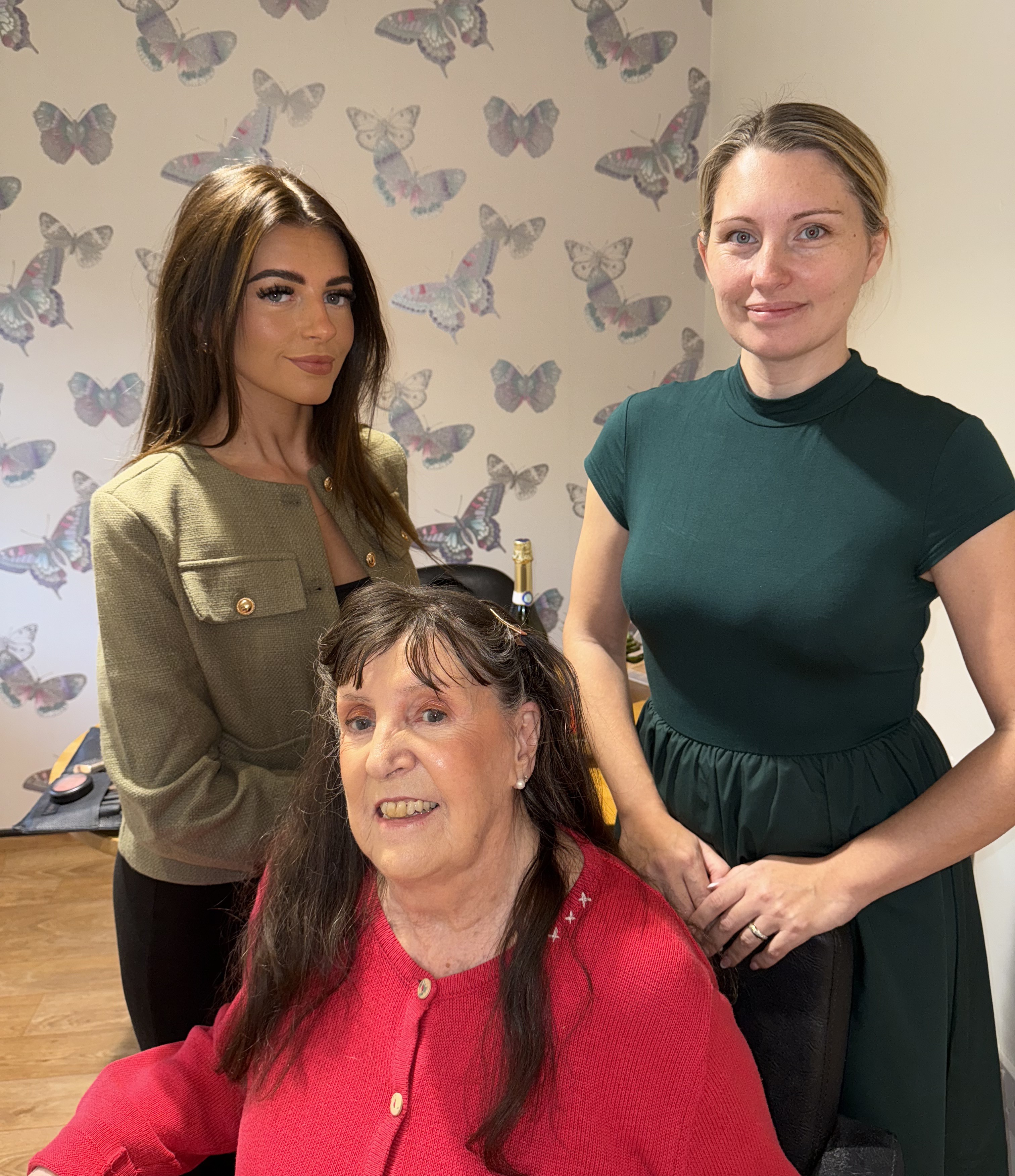 l-r Amy Gibbs, makeup artist, Lake House resident Pat and Alexandra Grindle, Home Manager