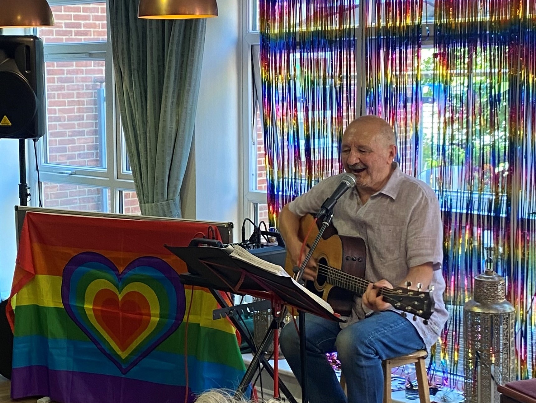 Entertainer Chico singing for residents at Avonbourne Care Centre during Pride month.