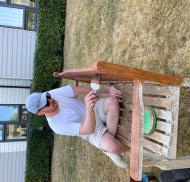 Volunteer staining outdoor seating