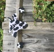 Painted cow-themed garden artwork
