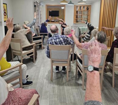 Residents enjoying a relaxing seated yoga session 