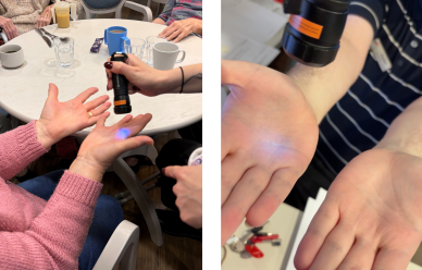UV light being used to check hands during an Infection Prevention Week hand hygiene activity.