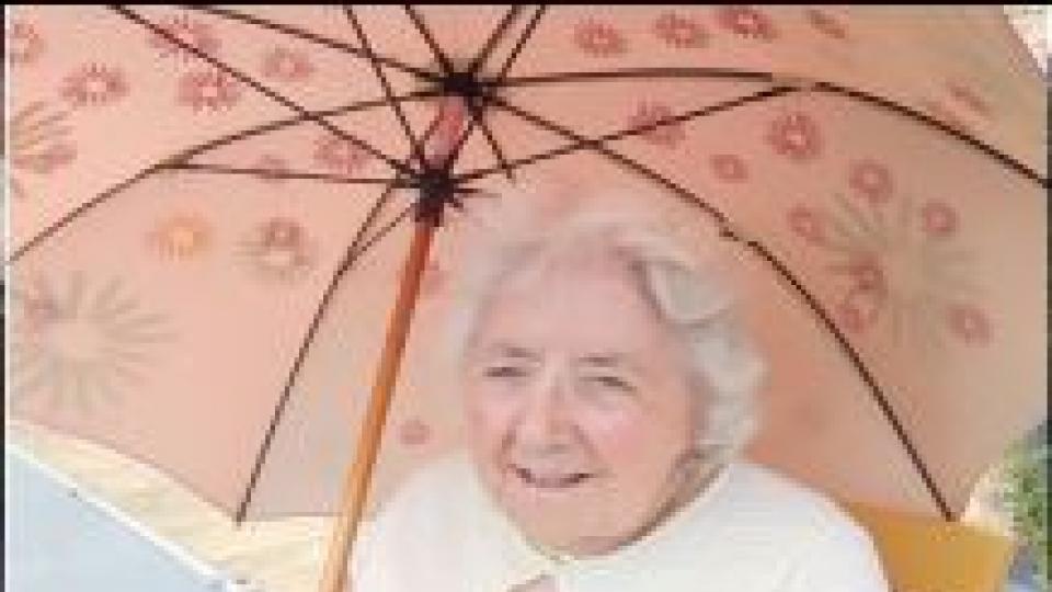 Lady with parasol enjoying outside entertainment
