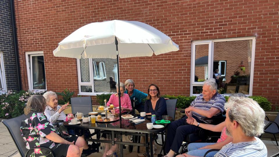 Residents  and staff enjoy afternoon tea with Caroline Newton