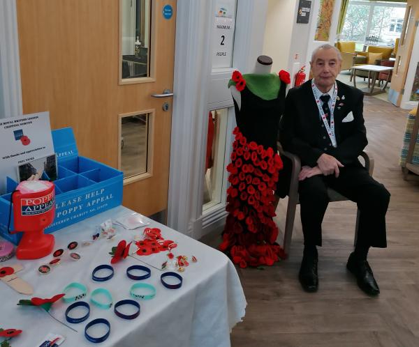 Veteran resident Phil sells Remembrance poppies at Henry Cornish