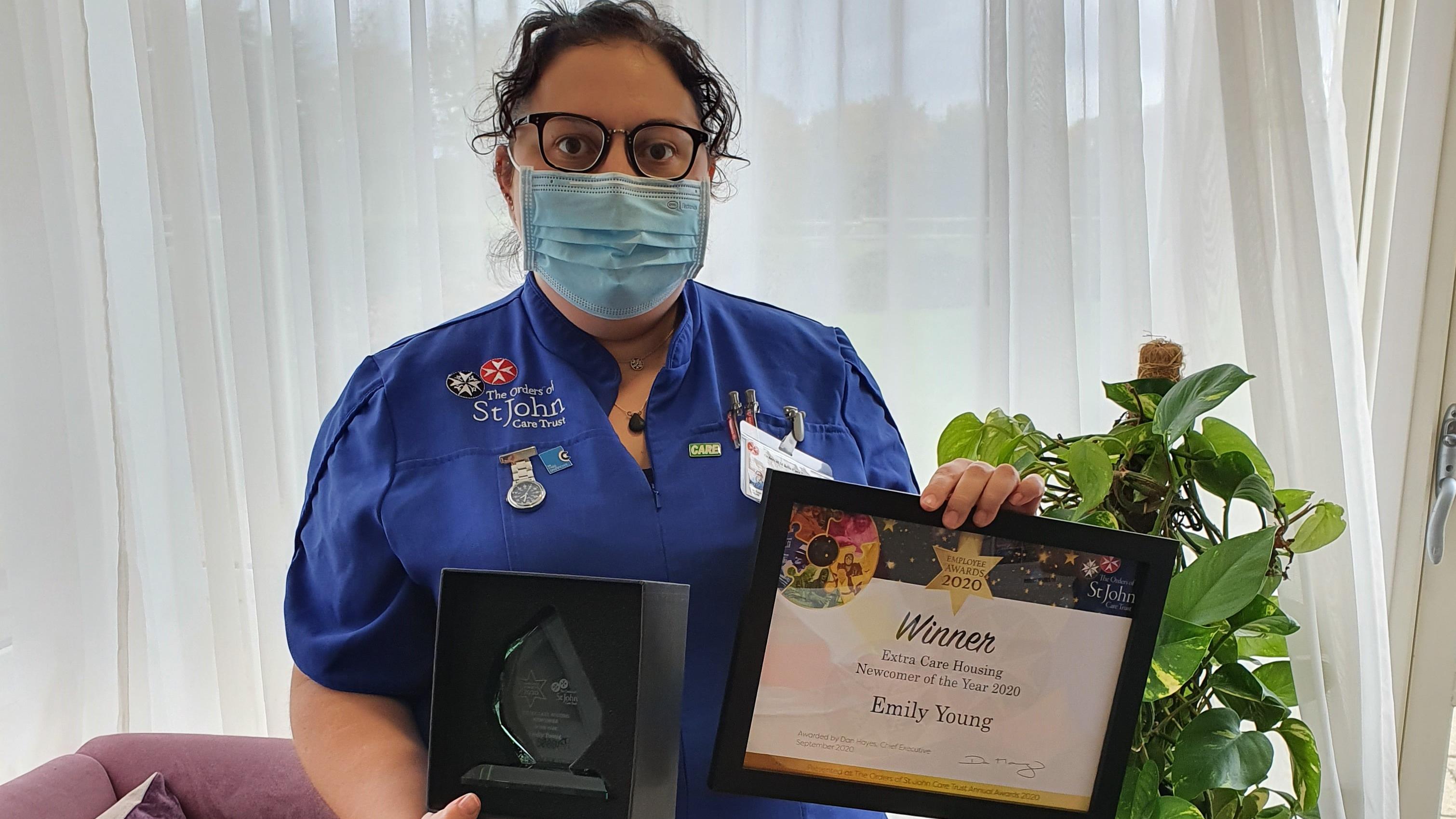 Emily Young holding her Award