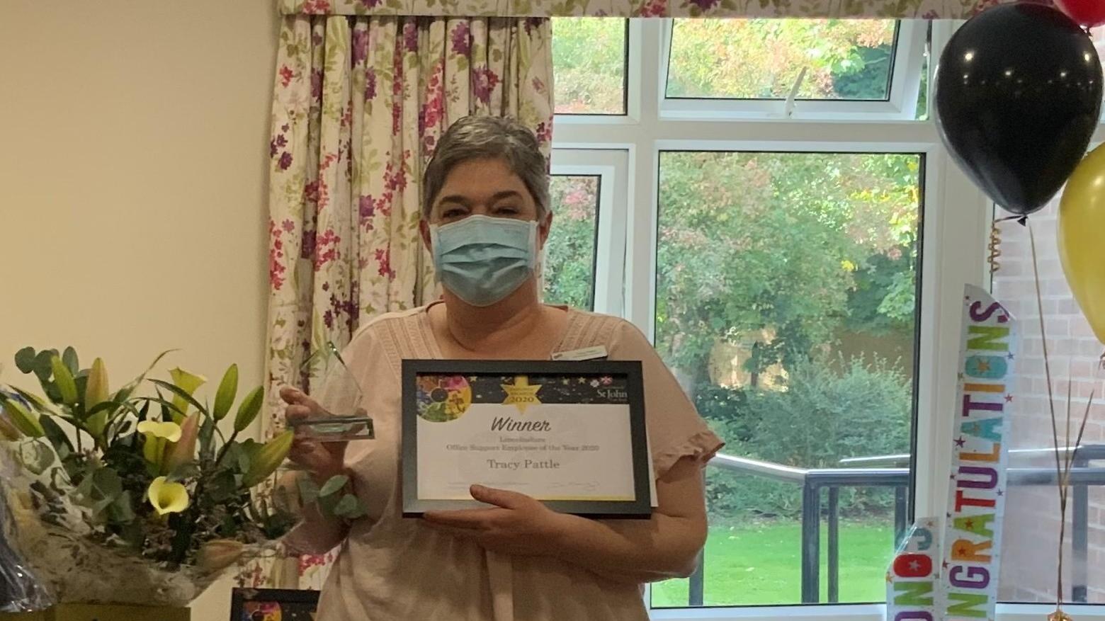 Tracy with Award and Flowers