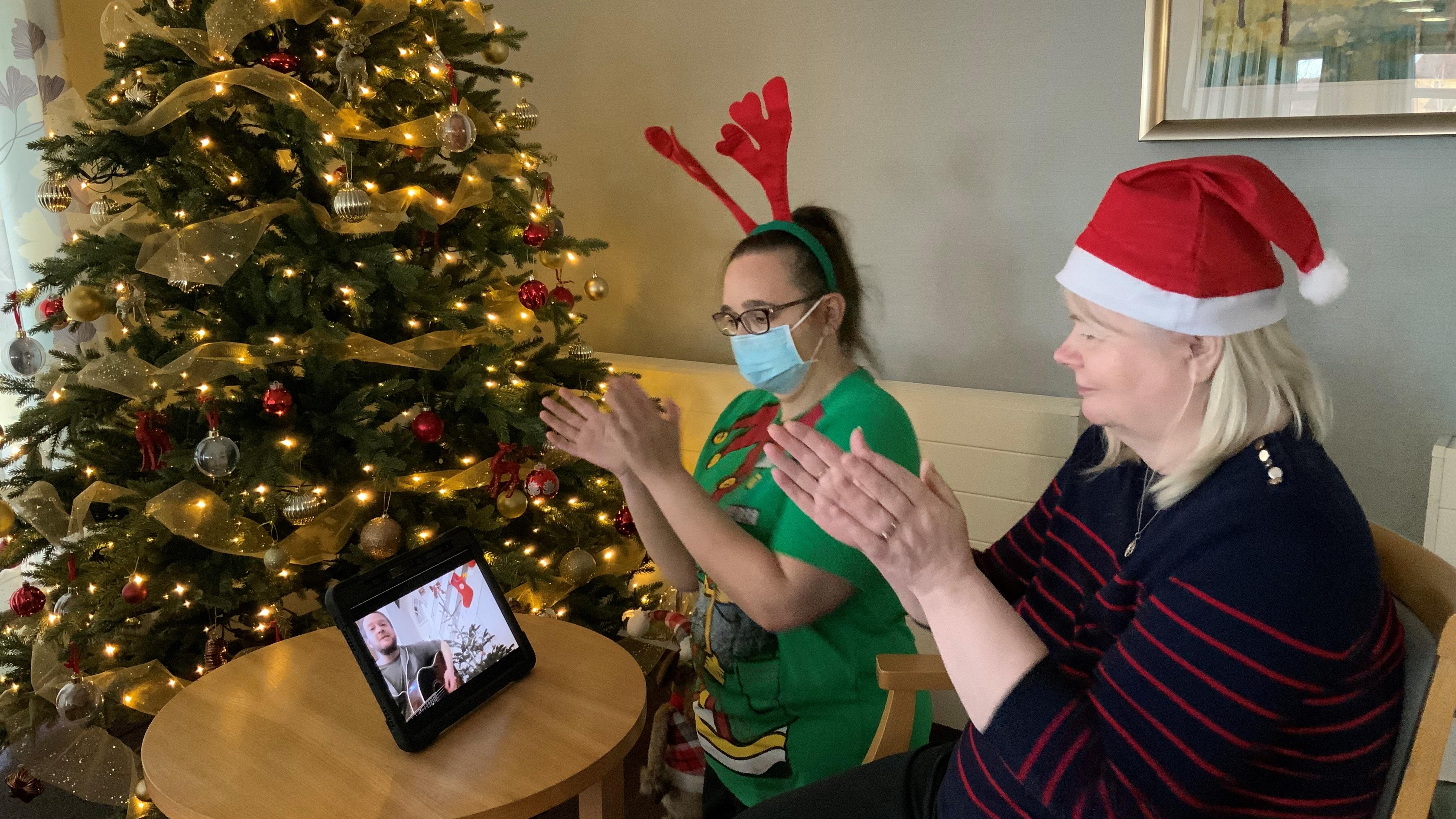 AC Sarah and resident watching Chris perform the song