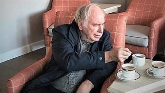 Tony watching The Crown in the cinema room at Grace Care Centre