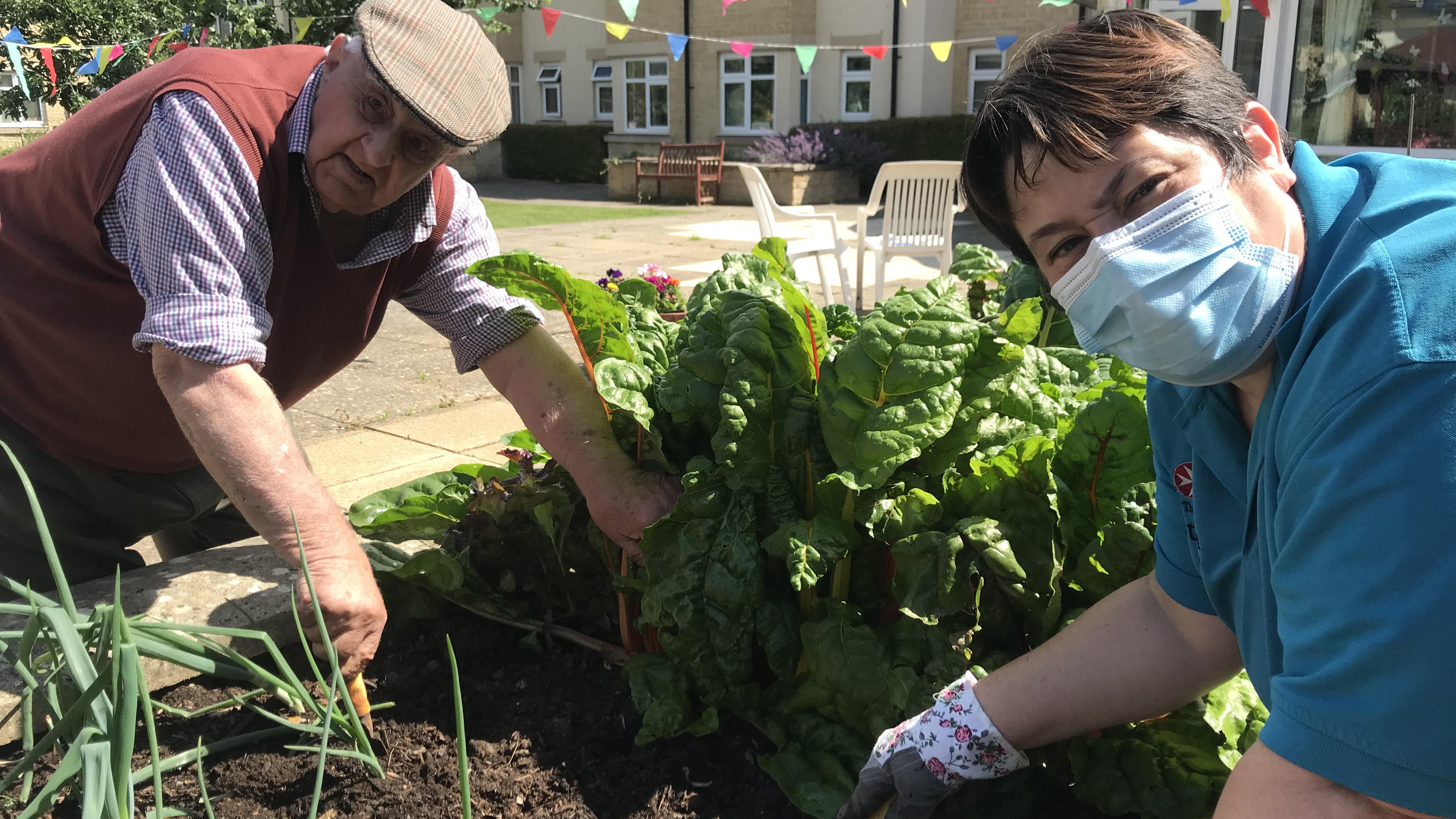 Reisdent Ron and Activities Coordinator Tina gardening at Henry Cornish Care Centre