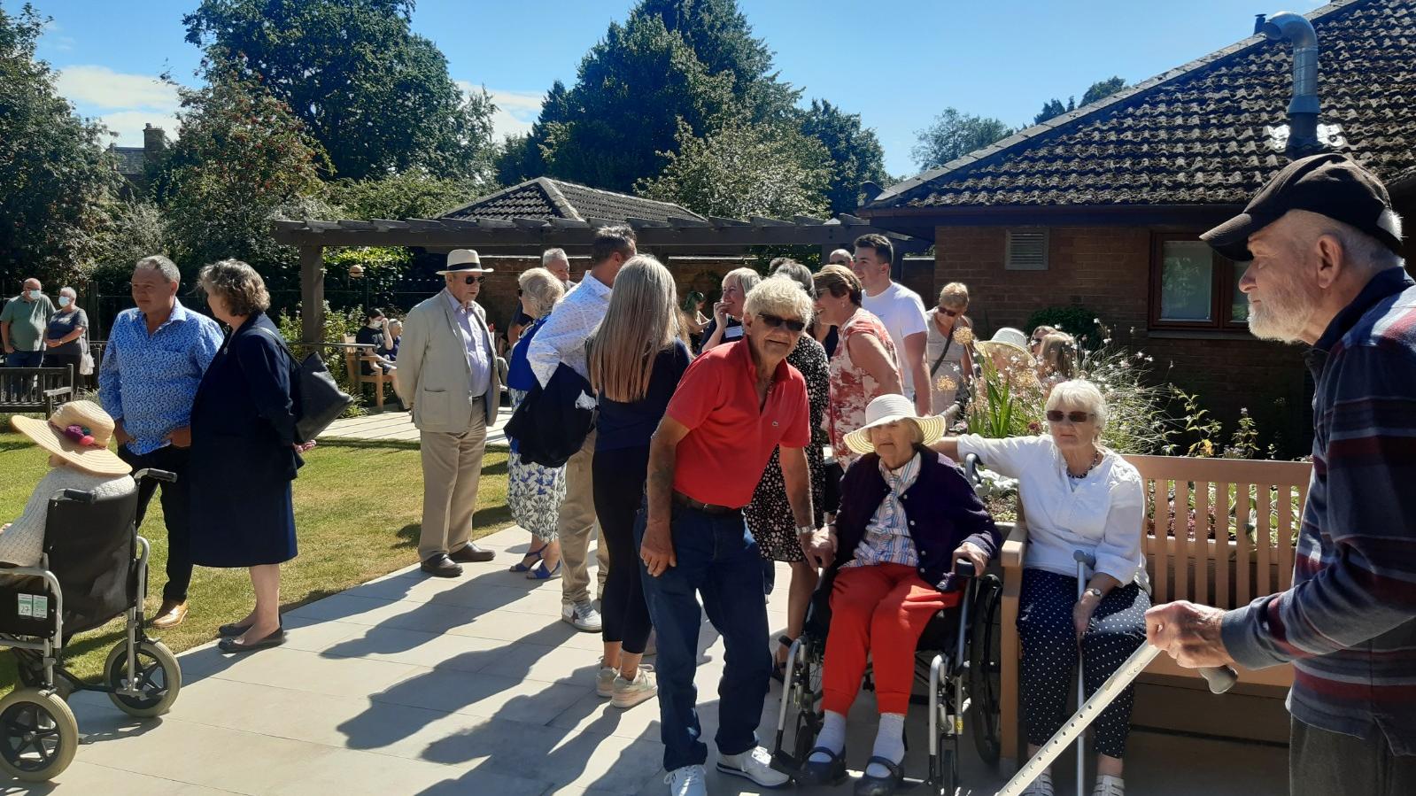 Residents, families, friends and members of the local community enjoying the Lake House garden