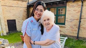 Nurse Maricar Padaguan and resident Barbara Carpenter, age 86, at Grevill House