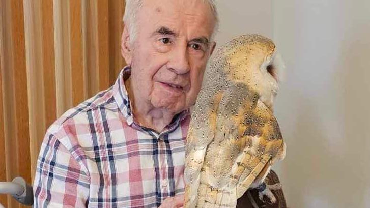 Ron enjoys a visit from an owl at Goodson Lodge
