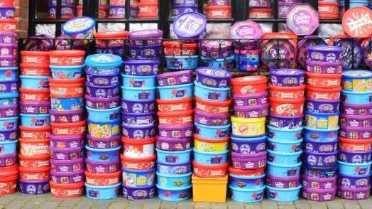 Tubs of sweets stacked against a wall