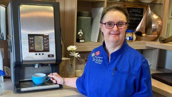 Sandra at the coffee machine helping out