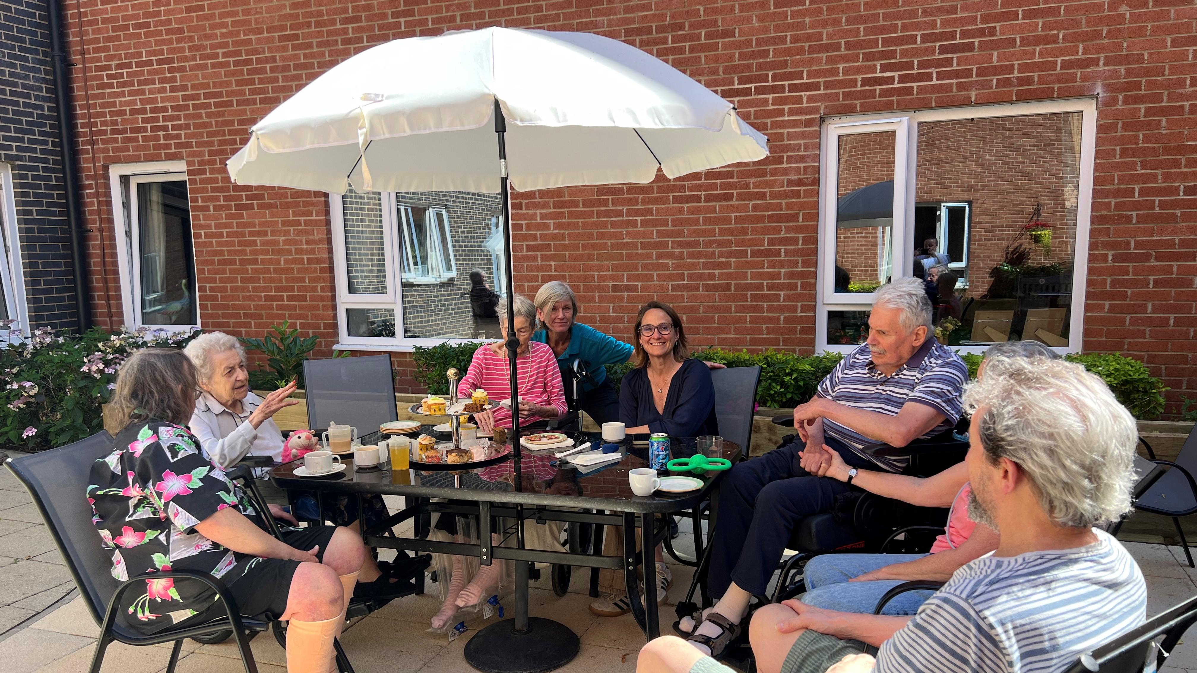 Residents  and staff enjoy afternoon tea with Caroline Newton
