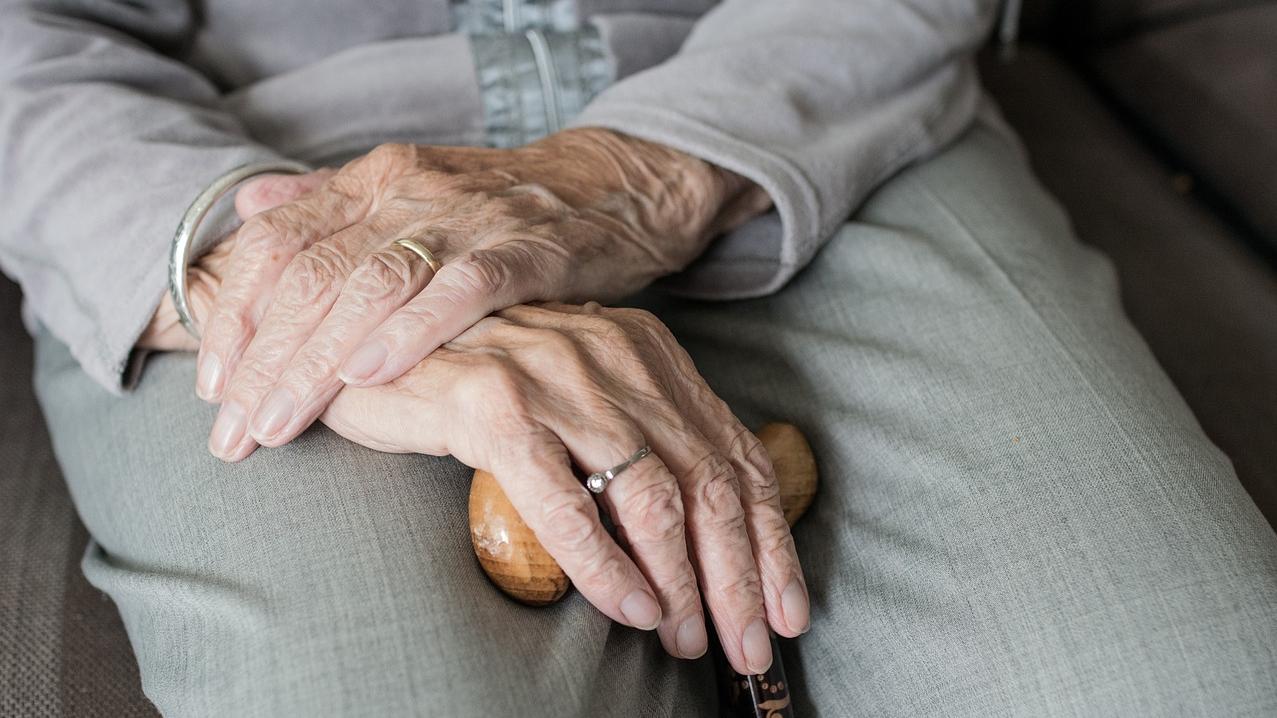 image shows hands clasped in an elderly lady's lap