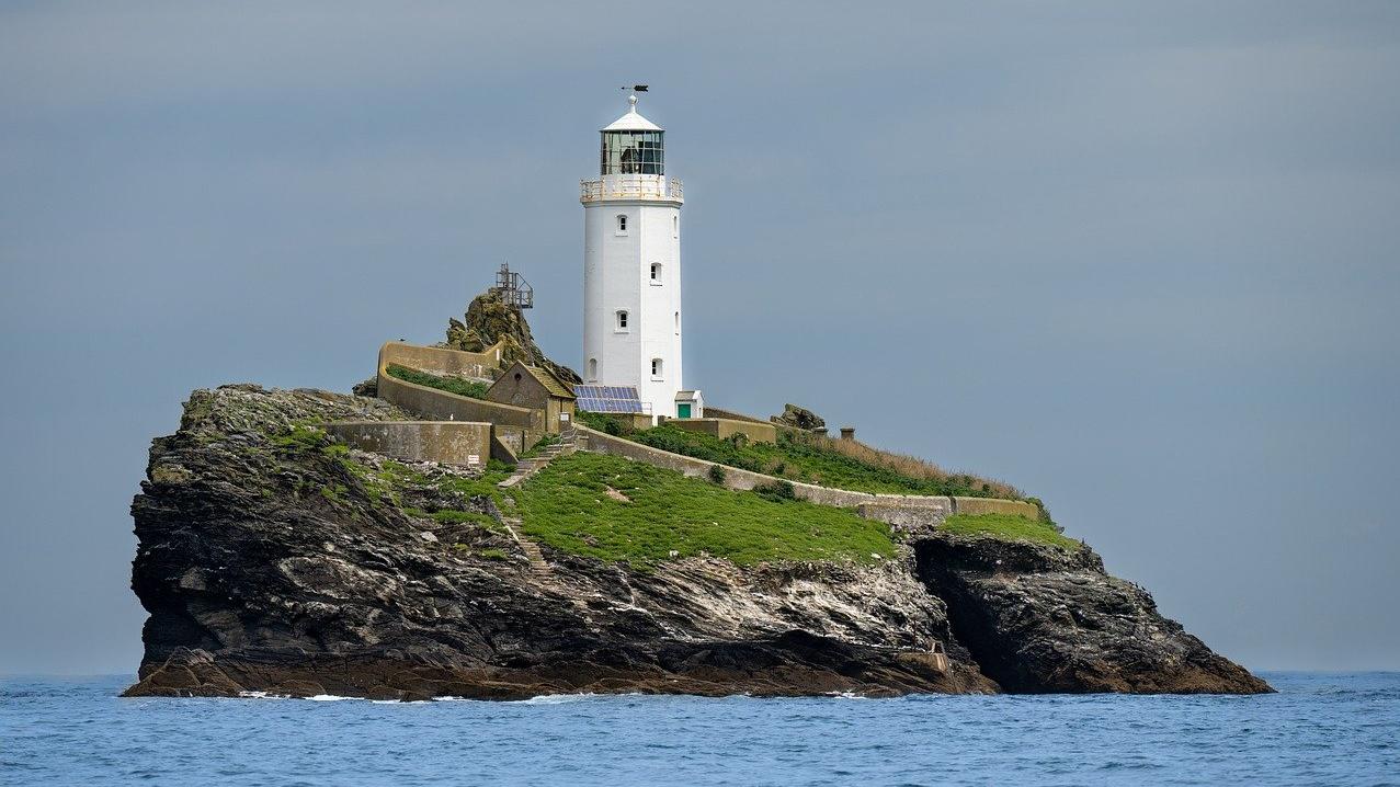 image shows a lighthouse on an island