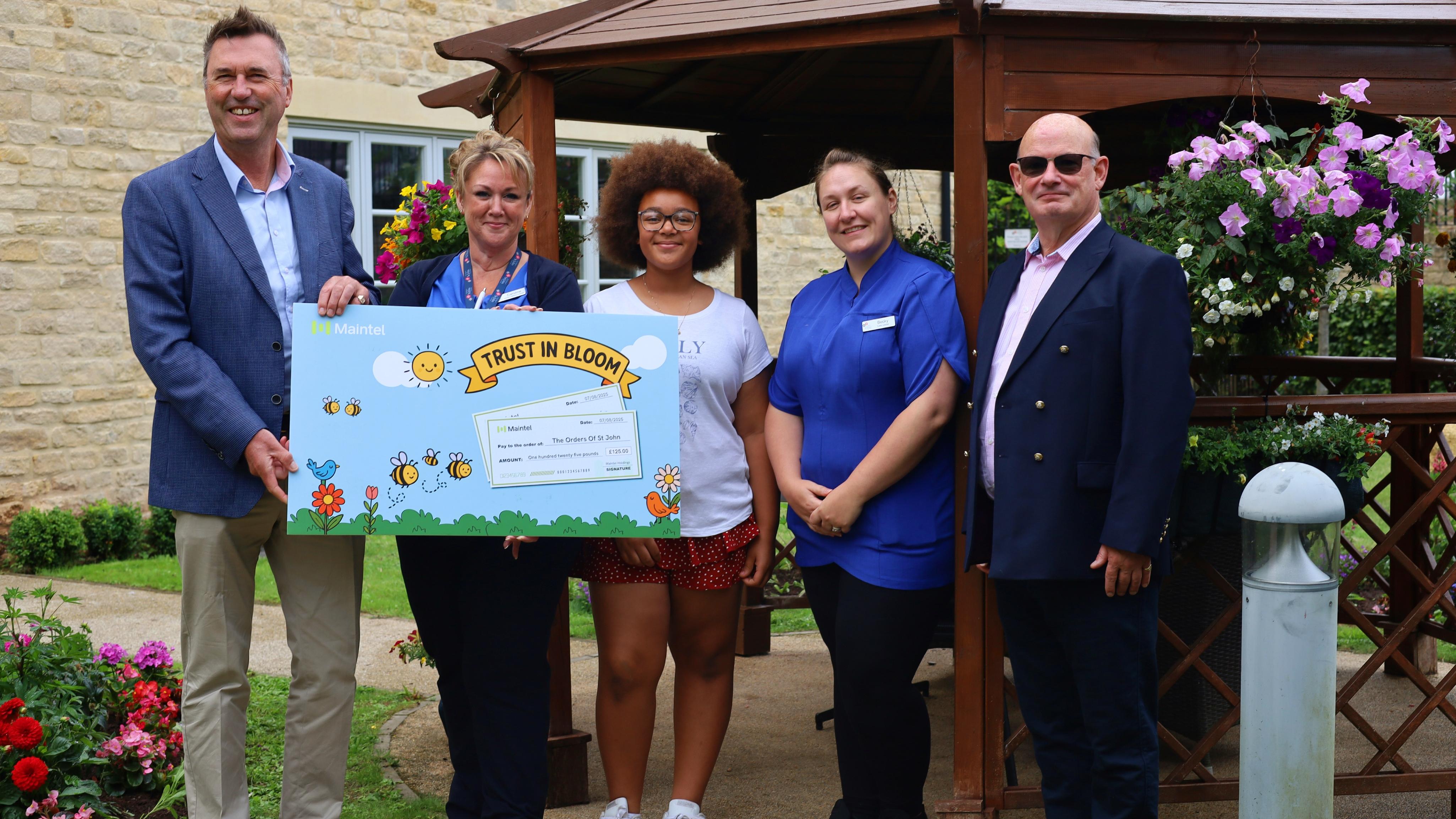 Edwardstow Court team members and volunteers with representatives from sponsors Maintel