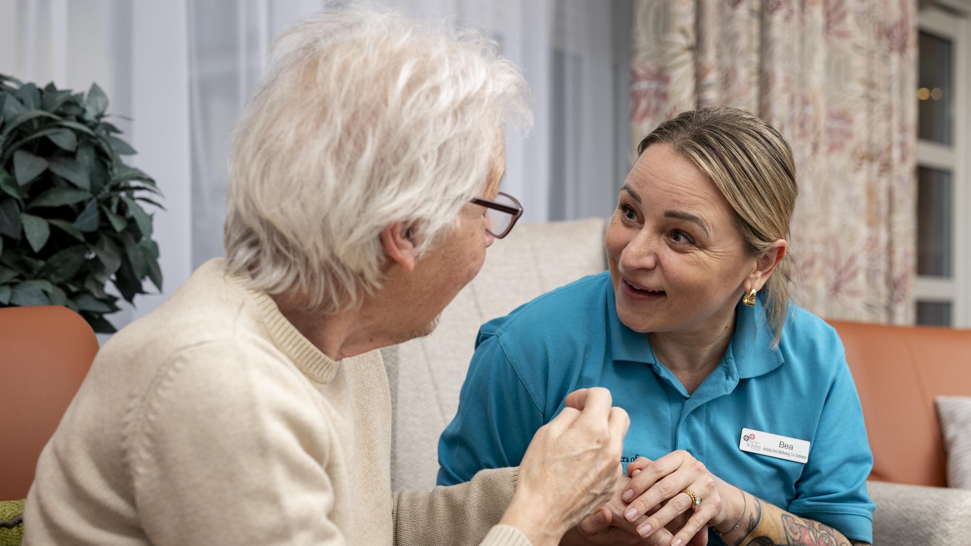 Resident and staff chatting