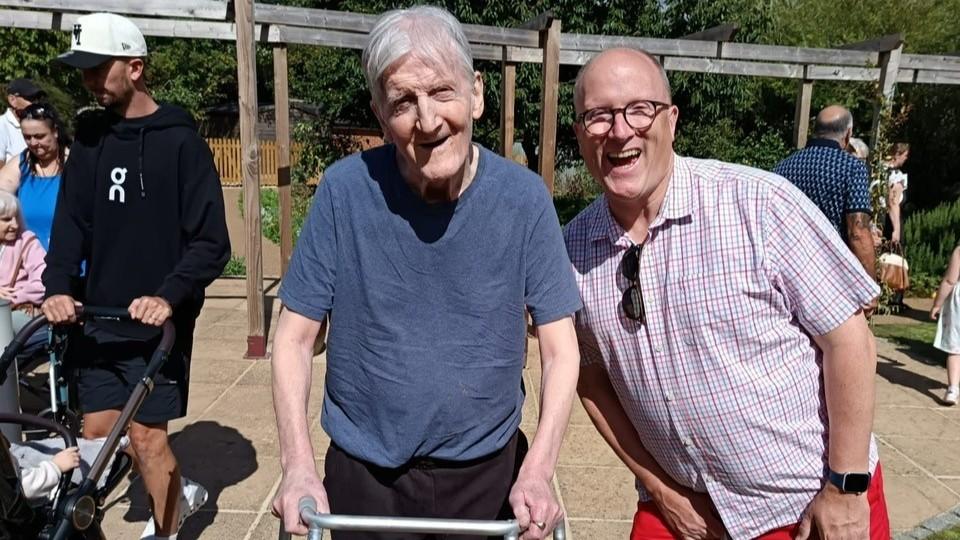 Resident Bill enjoying summer fete with his son