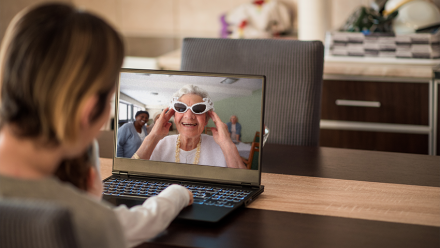 Families communicating via laptop and video call