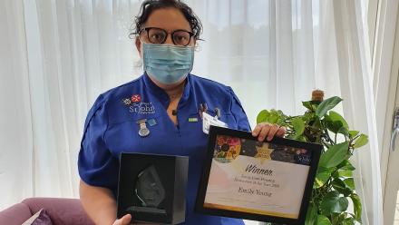 Emily Young holding her Award