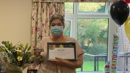 Tracy with Award and Flowers