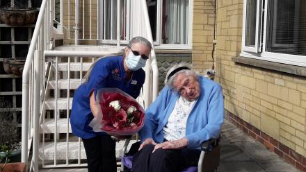 Lorraine presented with flowers by resident Margaret