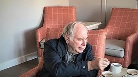 Tony watching The Crown in the cinema room at Grace Care Centre