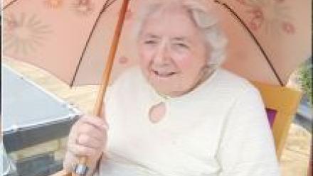 Lady with parasol enjoying outside entertainment