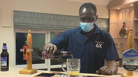 Malick pours at beer at the new onsite pub