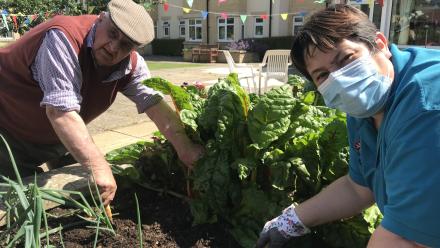 Reisdent Ron and Activities Coordinator Tina gardening at Henry Cornish Care Centre