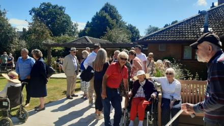 Residents, families, friends and members of the local community enjoying the Lake House garden