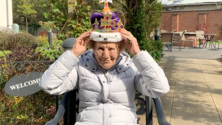 Resident holding a crown