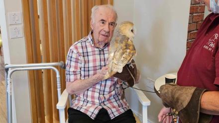 Ron enjoys a visit from an owl at Goodson Lodge