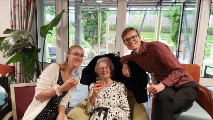 Resident and team members enjoying cocktail evening.