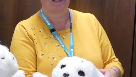Lead Admiral Nurse Angie Williams with a robotic Paro seal
