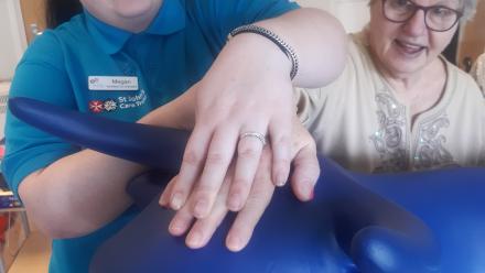 Megan Palmer, Activities Co-ordinator at Longlands and resident Franka Toglia decorate the ox for Oxtrail