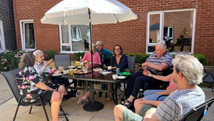 Residents  and staff enjoy afternoon tea with Caroline Newton