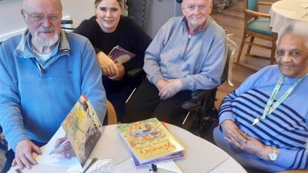 Longlands Home Manager Kelly and residents Peter and Olga enjoy meeting book illustrator Korky Paul
