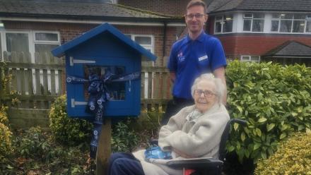 Martin with resident Sheila and the new blue book library