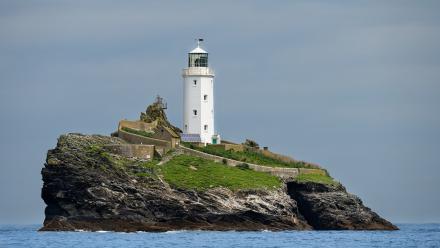 image shows a lighthouse on an island