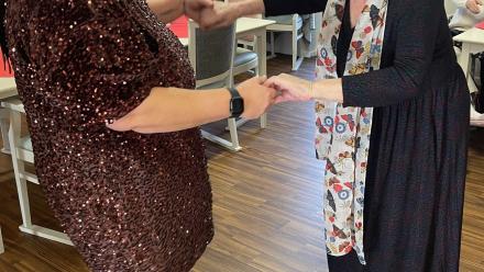 Resident Mary teaches Activities Co-ordinator Joanna Dixon to dance