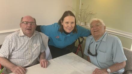 Angela Lindsay, Activities Co-ordinator, with Stirlings care home residents Mick and Vernon laughing together after completing the weekly quiz. 