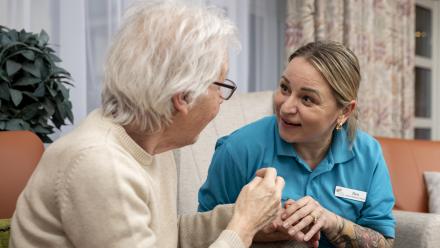 Resident and staff chatting